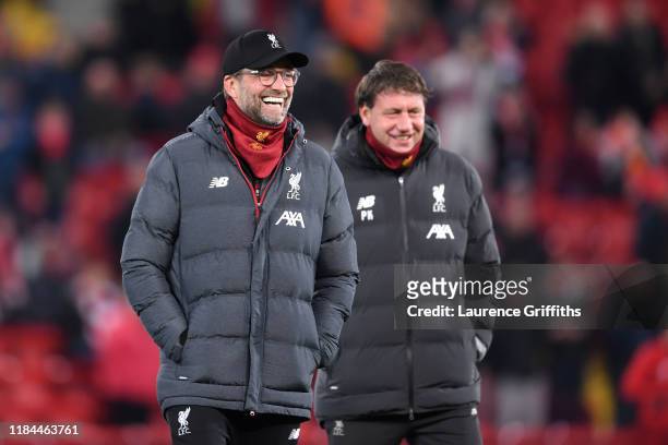 Jurgen Klopp, Manager of Liverpool and his assistant Peter Krawietz share a joke on the pitch prior to the Carabao Cup Round of 16 match between...