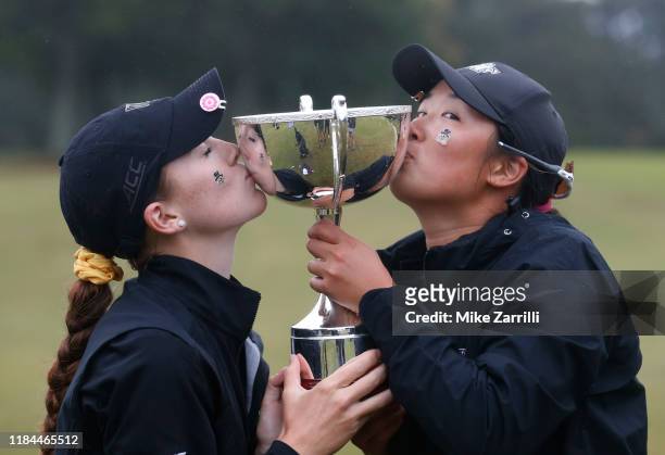 Emilia Migliaccio and Siyun Liu of the Wake Forest Women's Golf Team kiss the East Lake Cup after defeating the Auburn Tigers during Day 3 of the...