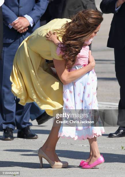 Catherine, Duchess of Cambridge hugs 6 year old terminal cancer sufferer Diamond as she arrives at Calgary Airport on July 7, 2011 in Calgary,...