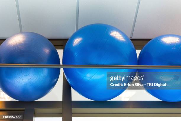 three blue pilates balls in the fitness room - blue sports ball stock pictures, royalty-free photos & images