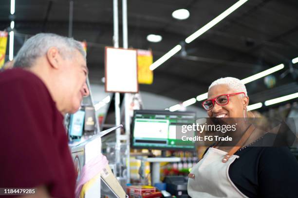 happy cashier working at wholesale - old man afro stock pictures, royalty-free photos & images