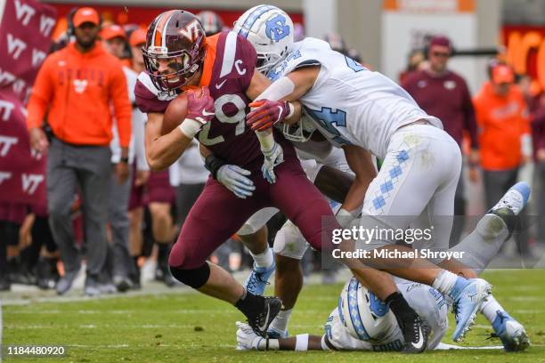 Tight end Dalton Keene of the Virginia Tech Hokies is hit during his carry by linebacker Jeremiah Gemmel of the North Carolina Tar Heels in the first...