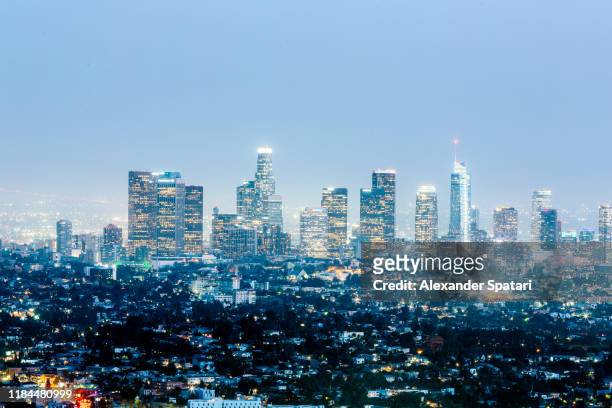 illuminated skyscrapers of los angeles downtown at night, california, usa - downtown los angeles aerial stock pictures, royalty-free photos & images