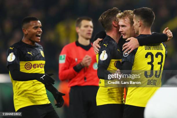 Julian Brandt of Borussia Dortmund celebrates after scoring his team's first goal with Mario Gotze and Julian Weigl during the DFB Cup second round...