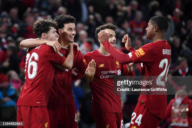 Neco Williams of Liverpool is congratulated by Curtis Jones and Rhian Brewster after assisting Liverpool's fifth goal of the game by during the...
