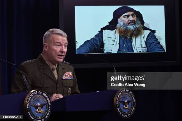 Marine Corps Gen. Kenneth McKenzie, commander of U.S. Central Command, speaks as a picture of Abu Bakr al-Baghdadi is seen during a press briefing...