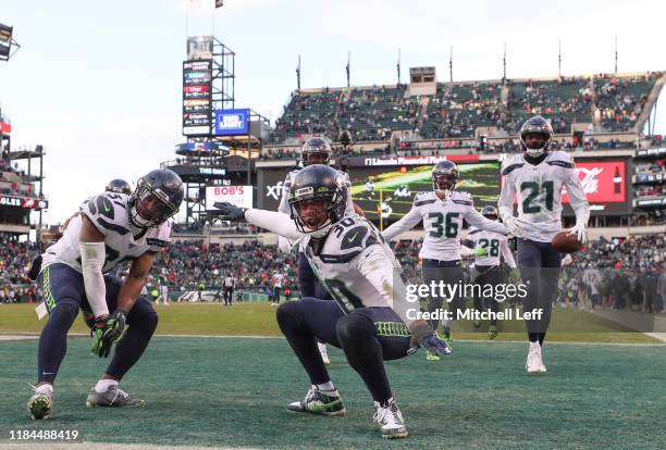 Quandre Diggs, Bradley McDougald, Akeem King, and Tre Flowers of the Seattle Seahawks react after an interception by Flowers against the Philadelphia...