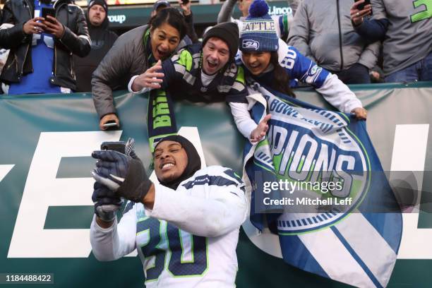 Bradley McDougald of the Seattle Seahawks takes a selfie with fans after the game against the Philadelphia Eagles at Lincoln Financial Field on...