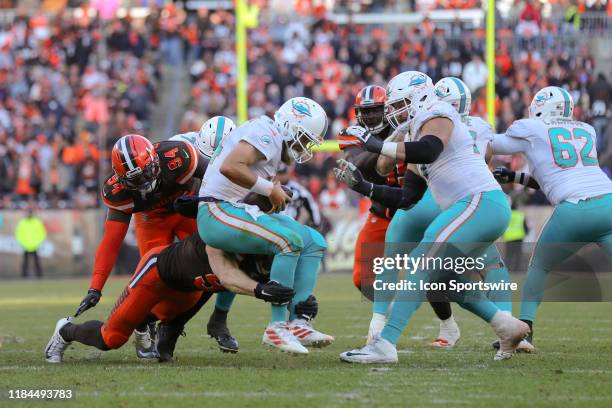 Cleveland Browns defensive end Bryan Cox and Cleveland Browns defensive end Porter Gustin combine to sack Miami Dolphins quarterback Ryan Fitzpatrick...