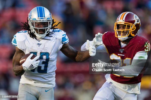 Bo Scarbrough of the Detroit Lions attempts to fight off the tackle of Fabian Moreau of the Washington Redskins during the second half at FedExField...