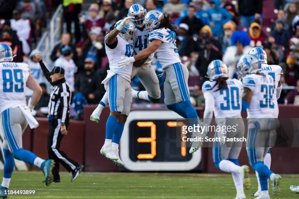 Jarrad Davis of the Detroit Lions celebrates with teammates after a play against the Washington Redskins during the second half at FedExField on...