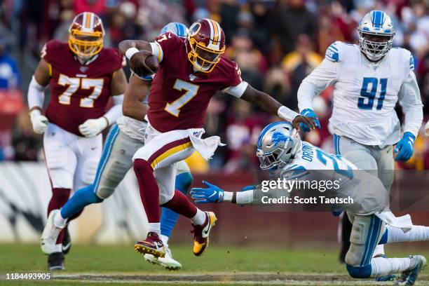 Dwayne Haskins of the Washington Redskins attempts to avoid the tackle of Amani Oruwariye of the Detroit Lions during the second half at FedExField...