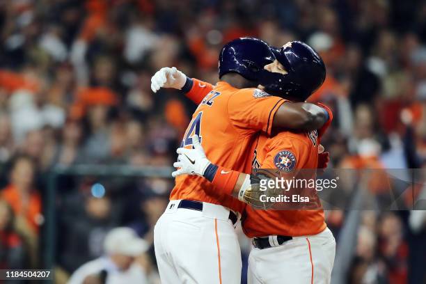 Yuli Gurriel of the Houston Astros is congratulated by his teammate Yordan Alvarez after hitting a solo home run against the Washington Nationals...