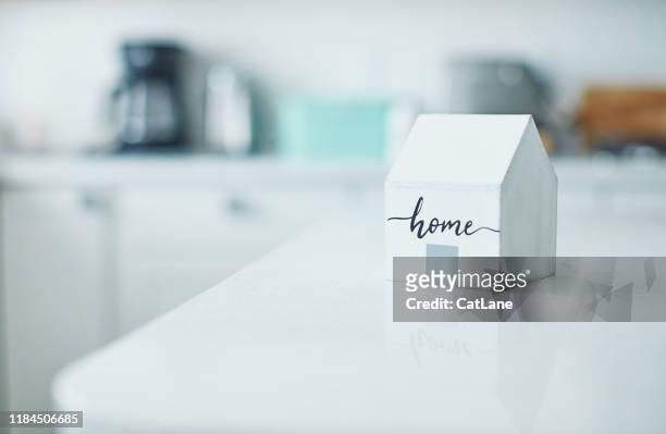little wooden home in bright white kitchen. new home concept. - sweet little models stock pictures, royalty-free photos & images