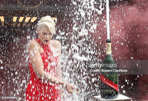 Australian model and television presenter, Kate Peck is showered in champagne at the opening of the Gh MUMM Marquee during the Birdcage Marquee...