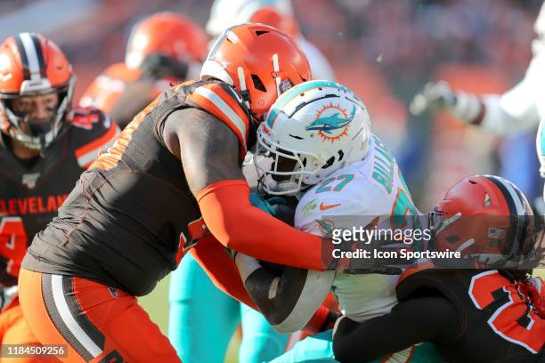 Cleveland Browns defensive tackle Sheldon Richardson and Cleveland Browns safety Sheldrick Redwine combine for a tackle on Miami Dolphins running...