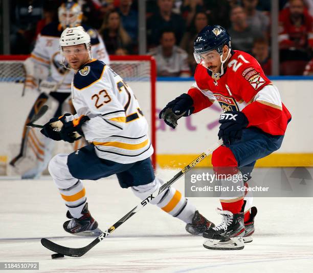 Vincent Trocheck of the Florida Panthers skates with the puck against Sam Reinhart of the Buffalo Sabres at the BB&T Center on November 24, 2019 in...