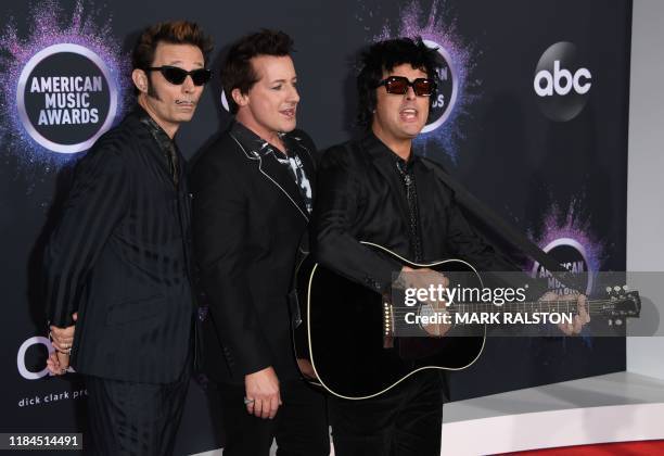 Mike Dirnt, Billie Joe Armstrong and Tre Cool from Green Day arrive for the 2019 American Music Awards at the Microsoft theatre on November 24, 2019...