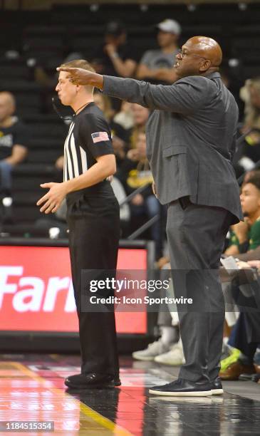 Cal Poly basketball coach John Smith gestures to his team in the second half during a non conference college basketball game between the Cal Poly...