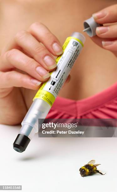 woman preparing epipen for bee sting - insulin pen stock pictures, royalty-free photos & images