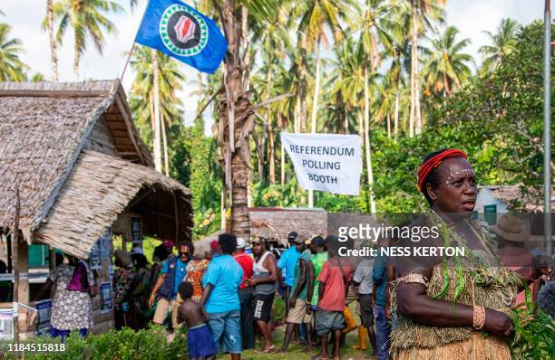 People queue to vote at a polling station in the capital Buka in an historical independence vote on November 25, 2019. - The resource-rich Pacific...