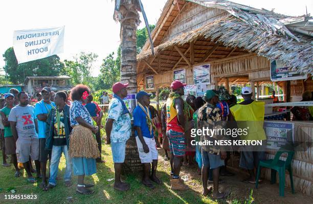 People queue to vote at a polling station in the capital Buka in an historical independence vote on November 25, 2019. - The resource-rich Pacific...
