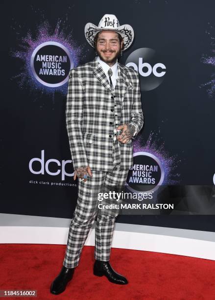 Rapper Post Malone arrive for the 2019 American Music Awards at the Microsoft theatre on November 24, 2019 in Los Angeles.