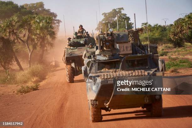 Two Armoured Personnel Carriers of the French Army patrol a rural area during the Bourgou IV operation in northern Burkina Faso on November 14, 2019....