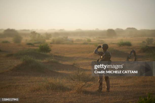 Soldier from the French Army monitors a rural area during the Bourgou IV operation in northern Burkina Faso, along the border with Mali and Niger, on...