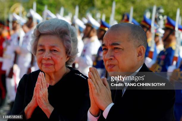 Cambodia's King Norodom Sihamoni and his mother former queen Monique walk pass honor guards during the cremation of Princess Norodom Buppha Devi in...