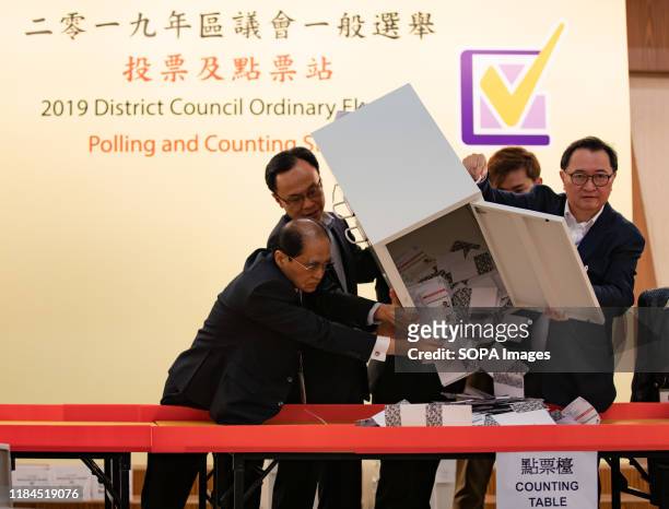 The Chairman of the HKSAR Electoral Affairs Commission , Barnabas Fung pours down the ballots from a ballot box to be counted at a polling station....