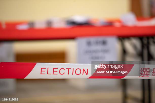 An election sign seen in front of the counting tables at a polling station. Nearly 3 million Hong Kong citizens cast their ballots on Sundays...