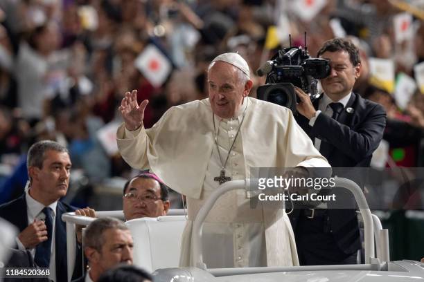 Pope Francis waves from the Popemobile as he drives around Tokyo Dome before conducting Mass on the third day of his four day visit to Japan, on...