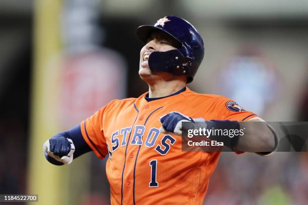 Carlos Correa of the Houston Astros celebrates after hitting an RBI single against the Washington Nationals during the fifth inning in Game Seven of...