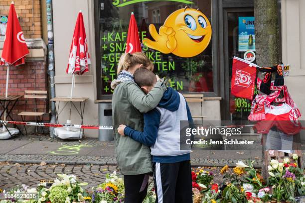 People mourn in front of a Doner kebab restaurant two days after a shooting left two people dead on October 11, 2019 in Halle, Germany. Stephan...