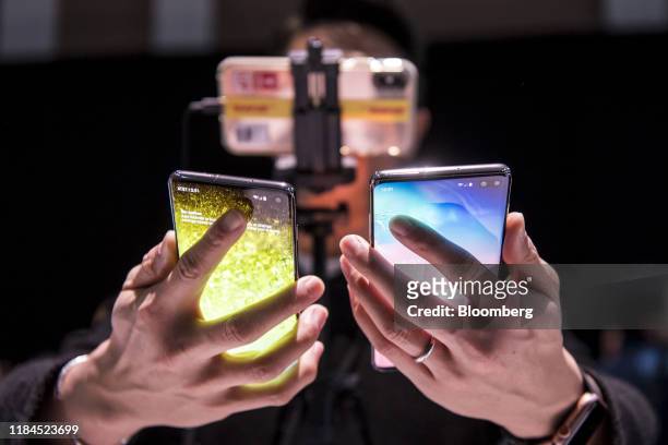 Bloomberg Best of the Year 2019: An attendee holds the Samsung Electronics Co. Galaxy S10, left, and the Galaxy S10+ during the Samsung Unpacked...