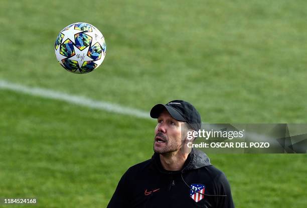 Atletico Madrid's Argentinian coach Diego Simeone attends a training session at the Atletico de Madrid Sports City in Majadahonda on November 25 on...