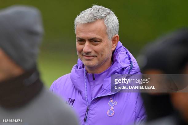Tottenham Hotspur's Portuguese head coach Jose Mourinho smiles as he takes a team training session at Tottenham Hotspur's Enfield Training Centre, in...