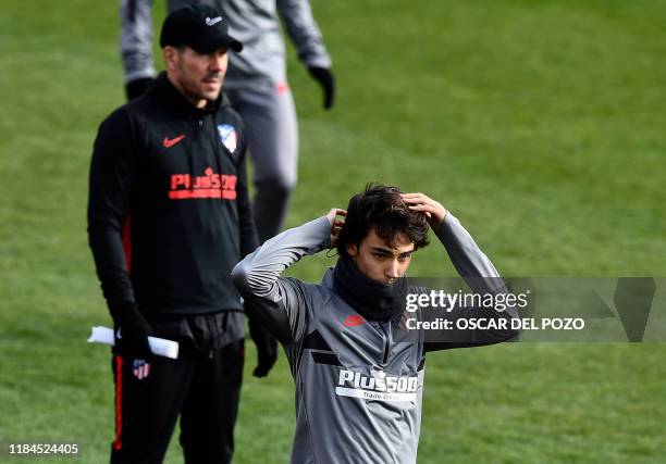 Atletico Madrid's Portuguese forward Joao Felix and Atletico Madrid's Argentinian coach Diego Simeone attend a training session at the Atletico de...