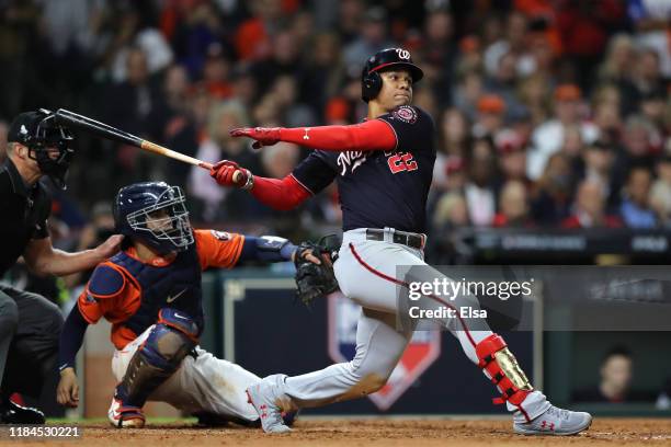 Juan Soto of the Washington Nationals hits an RBI single against the Houston Astros during the eighth inning in Game Seven of the 2019 World Series...