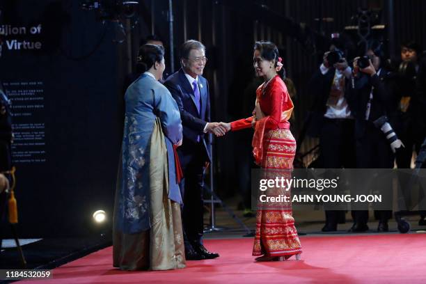 South Korea's President Moon Jae-in shakes hands with Myanmar's leader Aung San Suu Kyi as Moon's wife Kim Jung-sook looks on before a welcoming...