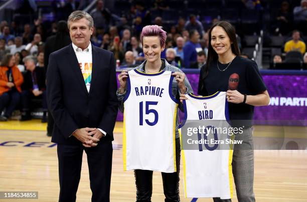 Soccer star Megan Rapinoe and WNBA star Sue Bird are given Golden State Warriors' jerseys by Warriors President & Chief Operating Officer Rick Welts...