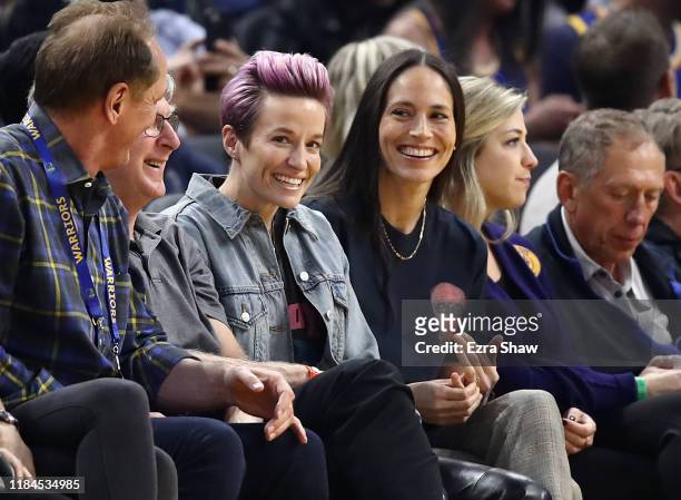 Soccer star Megan Rapinoe and WNBA star Sue Bird watch the Golden State Warriors play against the Phoenix Suns at Chase Center on October 30, 2019 in...