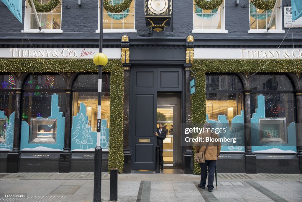 A security guard opens the front door of a Tiffany luxury