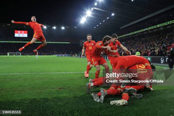 Wales players end up in a heap as they celebrate their 2nd goal, with Connor Roberts of Wales joining in, during the UEFA Euro 2020 Qualifier between...