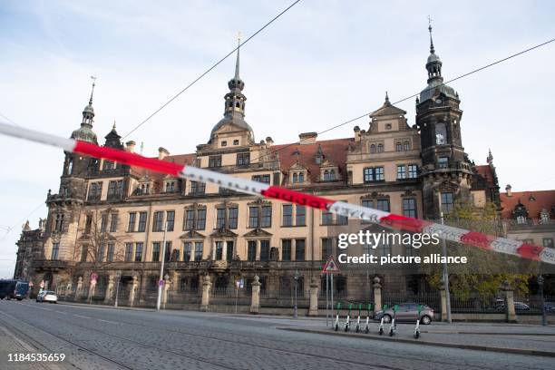 November 2019, Saxony, Dresden: A police barrier tape hangs in front of the Residenzschloss with the Green Vault. Dresden's Treasury Green Vault was...