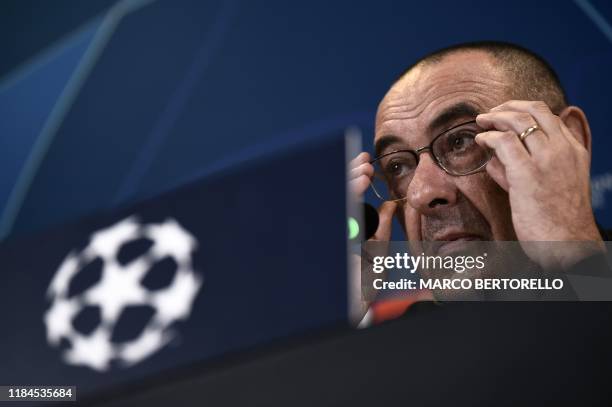 Juventus' Italian coach Maurizio Sarri adjusts his glasses during a press conference on November 25, 2019 at the Juventus Allianz stadium in Turin,...