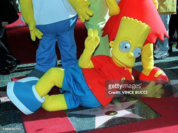 Bart Simpson, one of the stars of the animated television series "The Simpsons", poses next to the star they received 14 January 2000 on the famous...