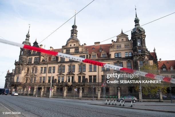 Police cordon hangs in front of the Royal Palace that houses the historic Green Vault in Dresden, eastern Germany on November 25 after it was broken...