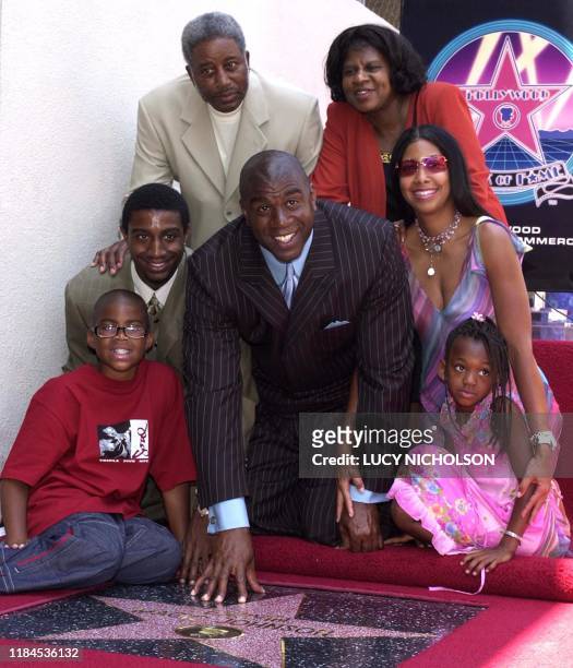 Former Los Angeles Lakers' basketball star Earvin "Magic" Johnson poses with his family : son Earvin Jr., son Andre, father Earvin Sr., mother...